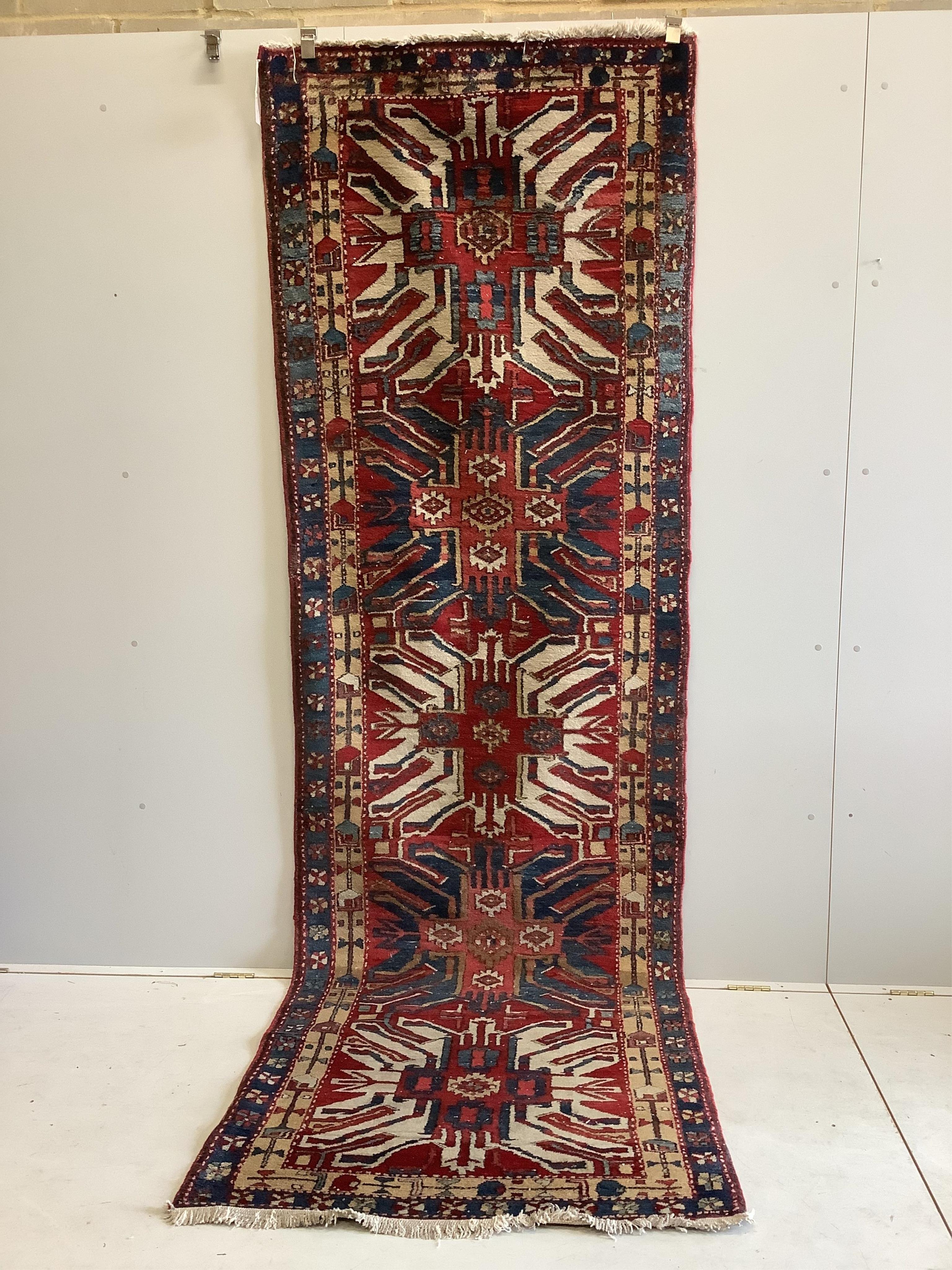 A Caucasian runner with stylised eagle motifs, 330 x 103cm
